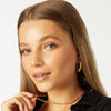 girl wearing large chunky hypoallergenic gold hoop earrings ||all