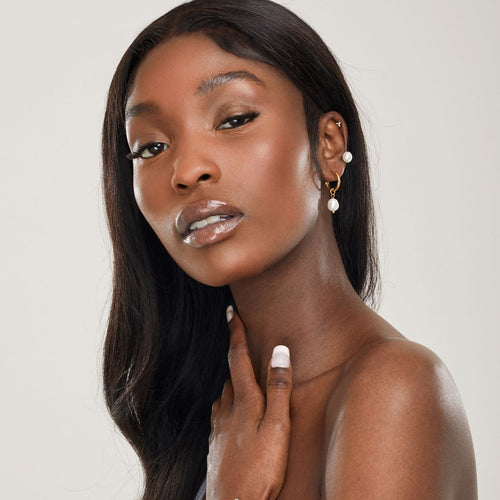 girl wearing titanium bridal hoop charm earrings with freshwater pearl and hypoallergenic bridal pearl stud earring in cartilage piercing ||all